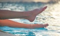 Young slim woman& x27;s legs relaxing near swimming pool in summer sun. Tropical vacation concept Royalty Free Stock Photo