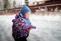 Young small boy walking and having photo shoot in park or forest full of snow in a cold winter day. Male child having Royalty Free Stock Photo