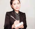 Young smart beautiful asian business woman wore black suit and glasses,smart and thinking holding Document, talking phone Royalty Free Stock Photo