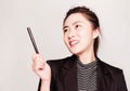 Young smart beautiful asian business woman wore black suit and glasses,smart and thinking holding Document, talking phone Royalty Free Stock Photo