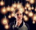 Young smart boy illuminated by light bulbs. Concept of creativity idea