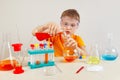 Young smart boy in safety goggles studies chemical practice in laboratory Royalty Free Stock Photo