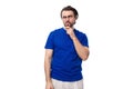 young smart caucasian man with dark well-groomed hair and a beard in a blue t-shirt on a white background