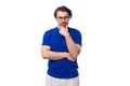 young smart caucasian man with dark well-groomed hair and a beard in a blue t-shirt on a white background