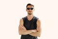 young smart hipster fashionable american male summer sleeveless tshirt clothes sunglass standing arm crossed isolated on clear