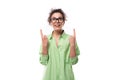 young smart inspired european brunette curly woman dressed in light green shirt and glasses