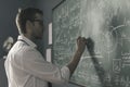 Young smart mathematician drawing on the chalkboard Royalty Free Stock Photo