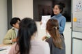 Young smart UX UI designer presenting her idea to the team, presentation during the team meeting Royalty Free Stock Photo