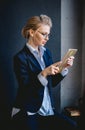 Young smart woman using her laptop while working in the office building Royalty Free Stock Photo