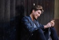 Young smartphone man sitting street