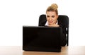 Young smile businesswoman behind the desk, using laptop Royalty Free Stock Photo