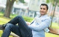 Young smile happy man sitting on bench Royalty Free Stock Photo