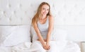 Young smile happy woman lying on white pillow in bed Royalty Free Stock Photo