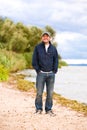 Young smile man on coast of river