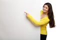 Young smile woman pointing at a blank board Royalty Free Stock Photo