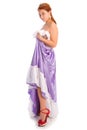 Young smiley woman in long lilac-coloured ball dress isolated on