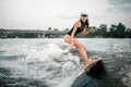 Active woman riding on the wakesurf on the river Royalty Free Stock Photo