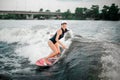 Young smiling active girl riding on the wakesurf Royalty Free Stock Photo