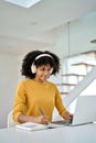 Young smiling African American woman student using laptop elearning at home. Royalty Free Stock Photo