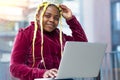 Young smiling african american woman working or studying using laptop Royalty Free Stock Photo