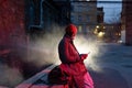 Smiling african man with smartphone on night street, black guy outdoors chatting in social media Royalty Free Stock Photo