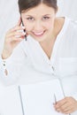 Young smiling asian businesswoman talking on the phone, seen in top view. Business, office, school and education concept Royalty Free Stock Photo