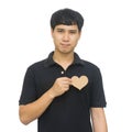 Young smiling asian man holding blank brown heart shape card Royalty Free Stock Photo