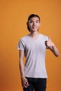 Young smiling asian man standing with thumb up portrait Royalty Free Stock Photo