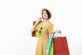 Young smiling asian woman holding multi coloured shopping bags and looking on white background. Royalty Free Stock Photo