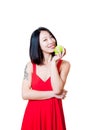 Young smiling asian woman red dress with green apple isolated Royalty Free Stock Photo