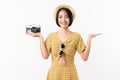 Young smiling Asian woman tourist holding camera and looking to copy space on white background. Royalty Free Stock Photo