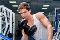 Young smiling athlete lifting weights in the gym Royalty Free Stock Photo