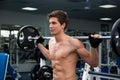 Young smiling athlete lifting weights in the gym Royalty Free Stock Photo