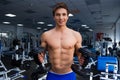 Young smiling athlete lifting weights in the gym Royalty Free Stock Photo