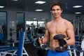 Young smiling athlete lifting weights in the gym Royalty Free Stock Photo