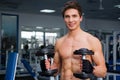 Young smiling athlete lifting weights in the gym Royalty Free Stock Photo