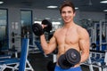 Young smiling athlete lifting weights in the gym Royalty Free Stock Photo