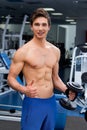 Young smiling athlete lifting weights in the gym Royalty Free Stock Photo