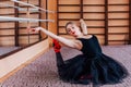 Young Smiling Ballerina Doing exercise in training hall