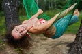 Young smiling barefooted woman swing in hammock