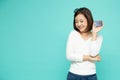 Young smiling beautiful Asian woman presenting credit card in hand for making payment shopping isolated Royalty Free Stock Photo