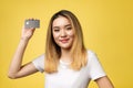Young smiling beautiful Asian woman presenting credit card in hand showing trust and confidence for making payment. Royalty Free Stock Photo