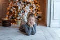 Young girl lies near a Christmas tree Royalty Free Stock Photo