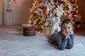 Young girl lies near a Christmas tree Royalty Free Stock Photo