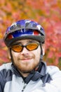 Young smiling bicycler on the background of autumn Royalty Free Stock Photo