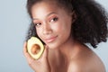 Young smiling black girl with clean perfect skin with avocado cl