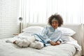 Young smiling black girl lying and resting on bed Royalty Free Stock Photo
