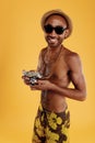 Young smiling black man holding old camera Royalty Free Stock Photo