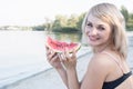 Young smiling blond woman with piece of watermelon Royalty Free Stock Photo