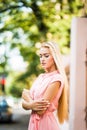 Young smiling blonde hair woman on the city streets on sunny day. Royalty Free Stock Photo